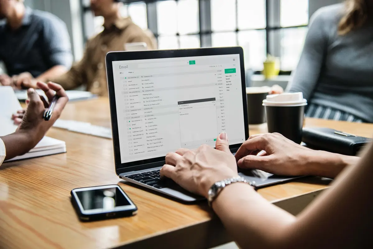 Person at desk on laptop - How to Avoid an Email Apocalypse - 7 Tips for Managing Your Inbox